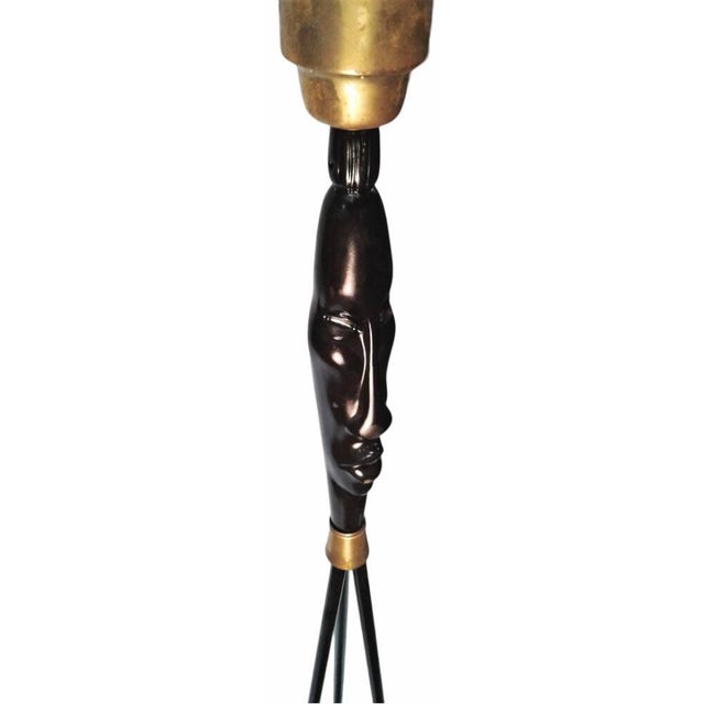 This rare 1940s Frederic Weinberg lamp showcases a tiki ceramic head adornment, blending mid-century modern design with...