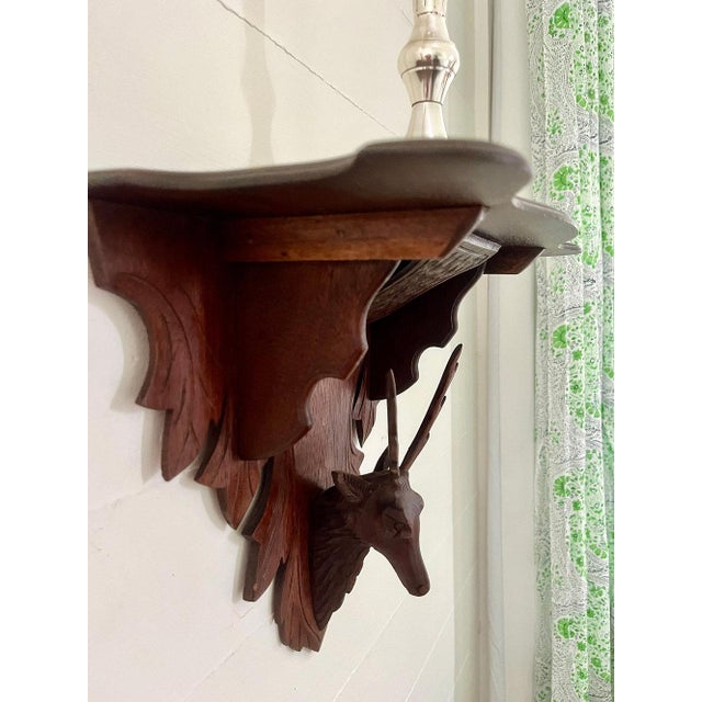 This handcarved corner shelf draws the eye in to appreciate both the bracket and the item displayed. Condition: Very good...