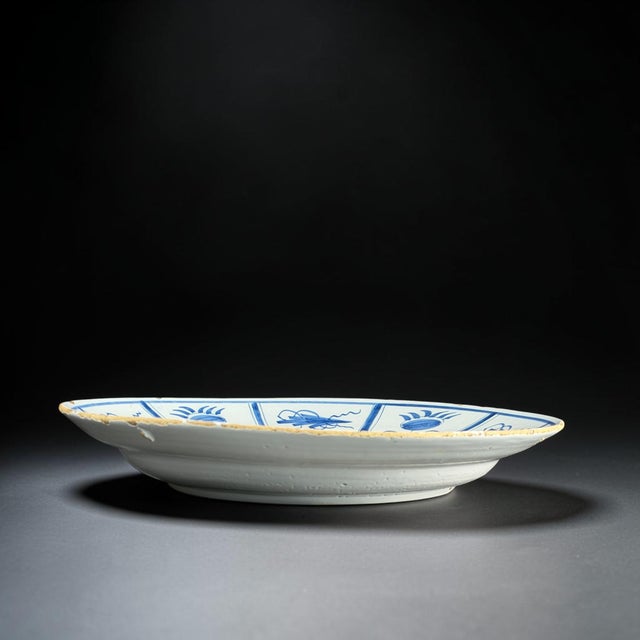 This large 18th-century Dutch Delft faience charger is hand-painted in cobalt blue under a tin glaze and features a finely...