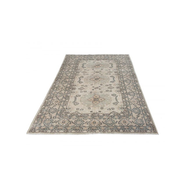 Decorative washed out handknotted vintage rug from Oushak region of Turkey. Approximately 50-60 years old. In very good...