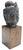 Vintage sculptural Buddha head with a dark, aged bronze finish, mounted on a simple solid wood pedestal. The serene...