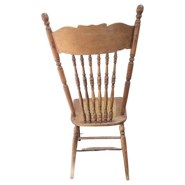 Pair of pressback oak chairs with caned seats. Good vintage condition. Measures 17.25"W x 19"D x 43"H Seat height is 18".