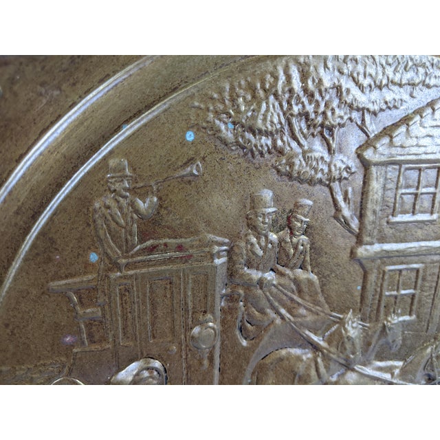A striking large-scale vintage English brass wall charger featuring an intricately embossed horse-drawn coach scene set...