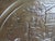 A striking large-scale vintage English brass wall charger featuring an intricately embossed horse-drawn coach scene set...