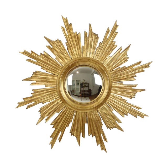 Rare wooden sunburst mirror, large format sunburst mirror with convex mirror glass; the mirror is made of wood gilded with...
