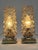 Set of two lovely and highly decorative mid-century modern brass and bubble glass bedside table lamps. Designed and...