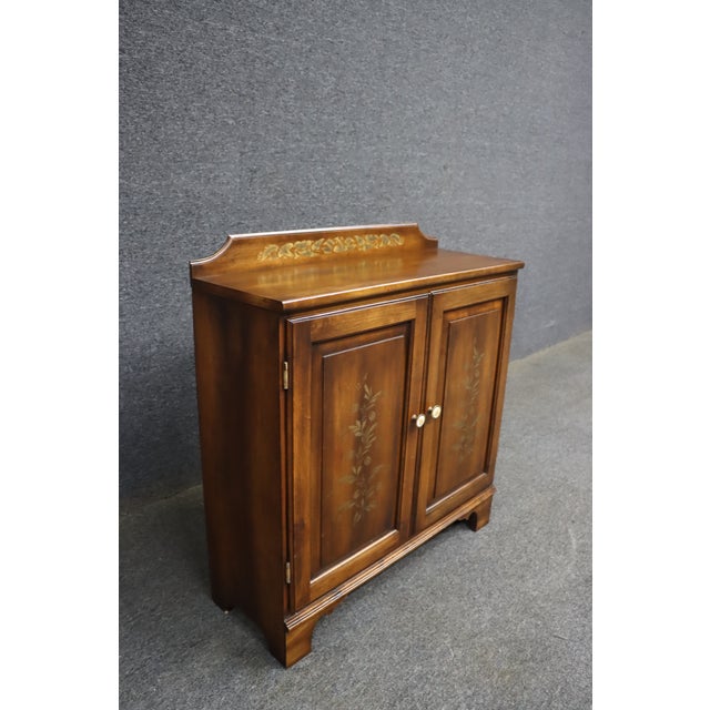 Hitchcock Furniture two-door maple console cabinet with traditional Early American styling and hand-applied floral stencil...