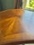 A traditional English Regency-revival accent table: an octagonal scalloped-edge top with a book-matched sunburst veneer...