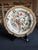 A set of four vintage Chinese export porcelain plates, each hand painted with a different monkey scene set among flowering...