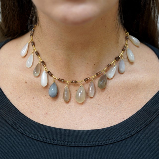 22K yellow gold necklace is strung with faceted rondelle cabochon beads, 8mm to 13mm wide, alternating with 13 multi-...