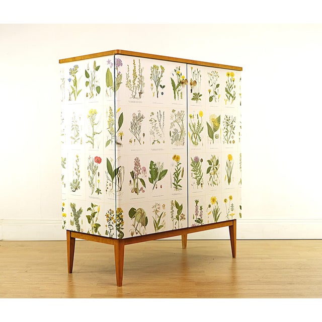 Vintage cabinet covered with illustrations ´Nordens Flora`by C.A.M Lindman, the same illustrations Josef Frank used when...