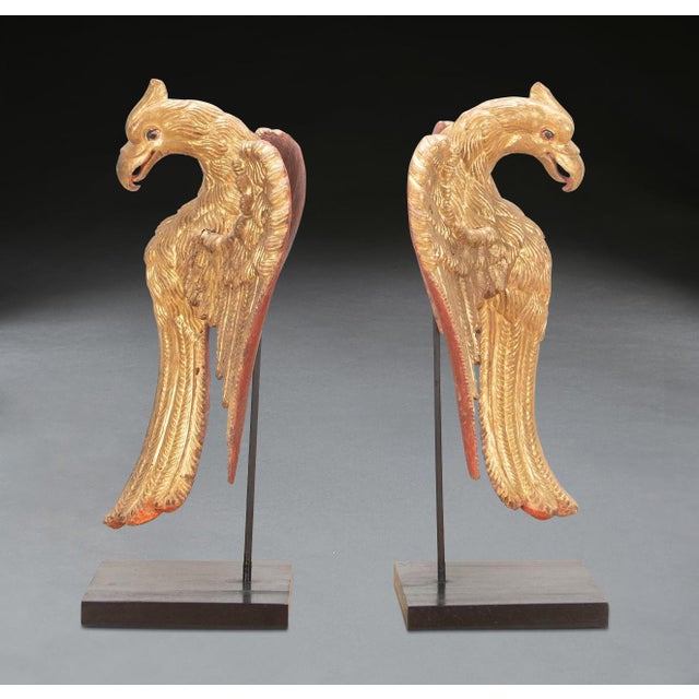 A rare pair of 19th century carved giltwood elements of eagles with widespread wings, indian, circa 1840. Artfully...