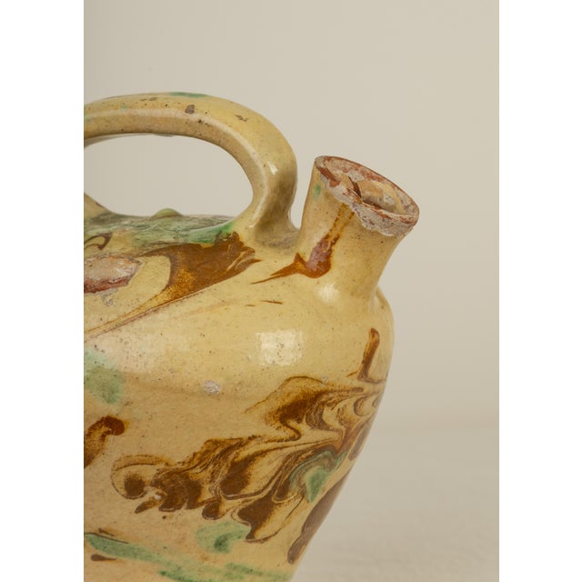 Charming 19th century French Provincial gargoulette from southern France. Double-spouted form with loop handle in ochre...