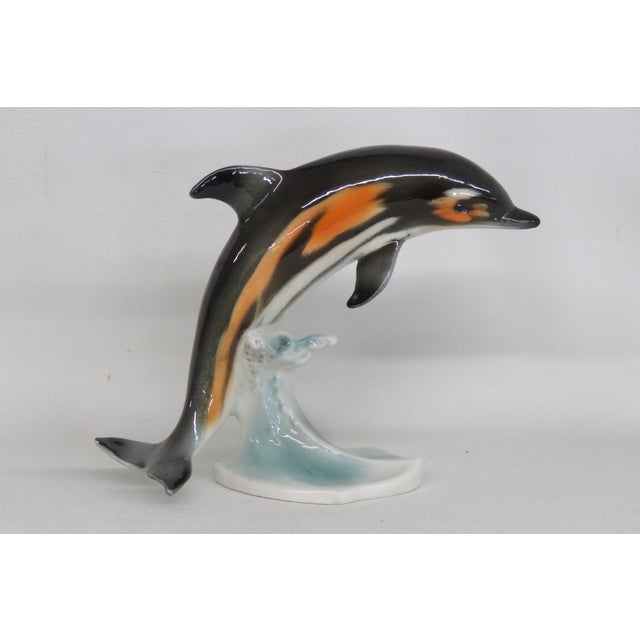 This Figurine is made of porcelain. This Dolphin Figurine was made in Germany by Goebel, it is stamped, and marked CS 209,...