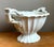 Elegantly crafted in the early 20th century, this Ironstone fluted porcelain footed orchid bowl embodies timeless...