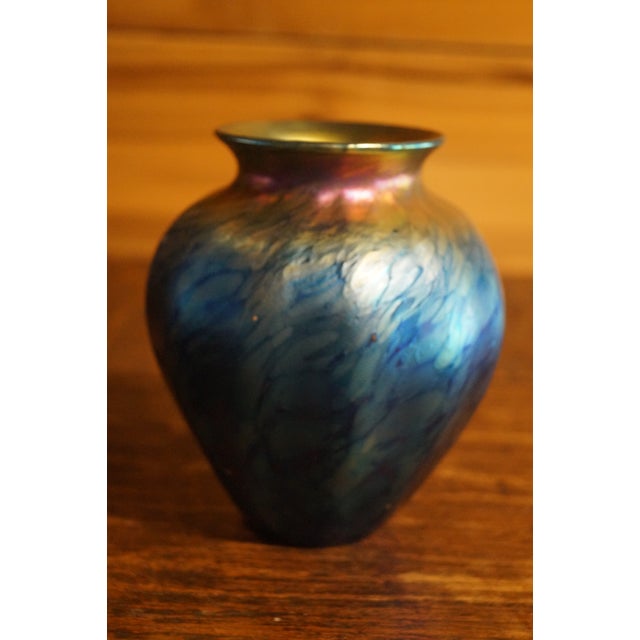 A beautiful hand blown art glass vase from Lundberg Studios. In very good condition. Measures 5.25 inches tall x 4.5 inches.