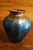 A beautiful hand blown art glass vase from Lundberg Studios. In very good condition. Measures 5.25 inches tall x 4.5 inches.