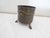 This brass container with lion masks on the sides, one with a handle, has a mark on the underside. The inner size is 9"...