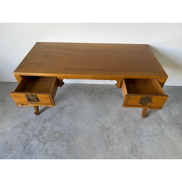 Elegant vintage writing desk by Baker Furniture, crafted in the timeless French Louis XV style. This refined piece...