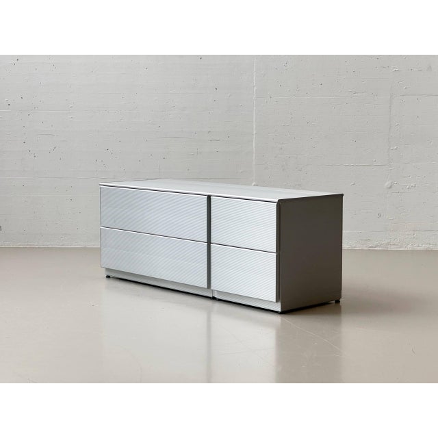 A striking, industrially elegant sideboard from the italian manufacturer ycami, crafted from silver-colored, finely...