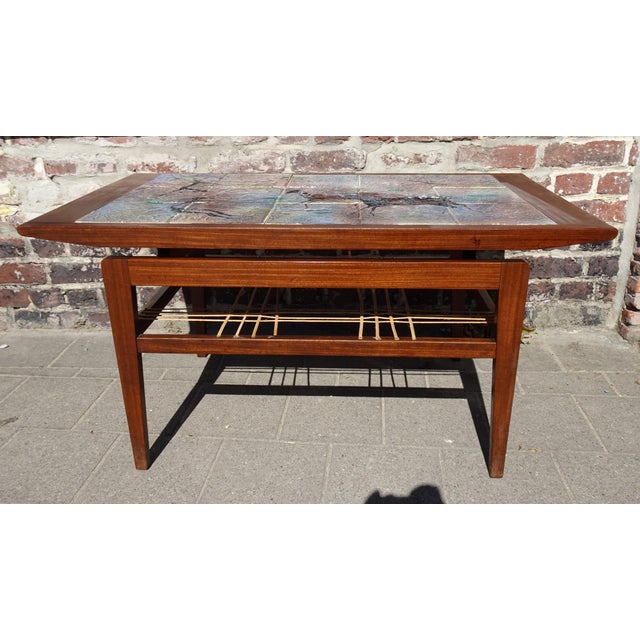 Teak Coffee Table with Ceramic Tiles from Vallauris Lascaux, 1950s, in Worn conditions. Designed 1950 to 1959 This piece...