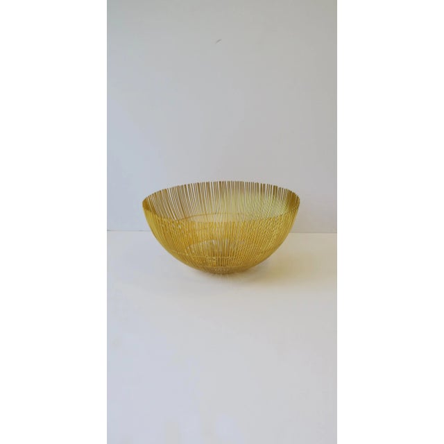 A great large bowl basket with a twig-like design in a bright gold hue. Bowl makes a beautiful standalone piece,...
