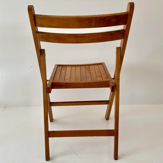 Four vintage wood slat folding chairs with functional details. Extremely sturdy. Made in Yugoslavia. This classic design...