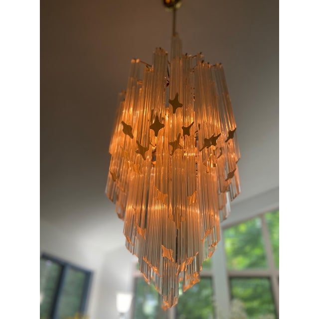 This superb Murano glass chandelier comes with 120 transparent quadriedri prisms on gold frame and 6 light bulbs. A circa...