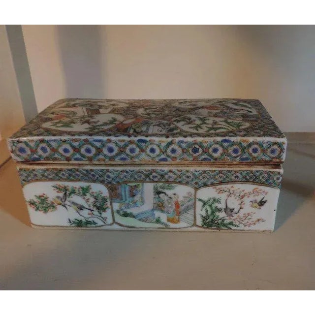 A beautiful early 19th c. Chinese porcelain covered box with divided interior. The box profusely decorated with reserves...