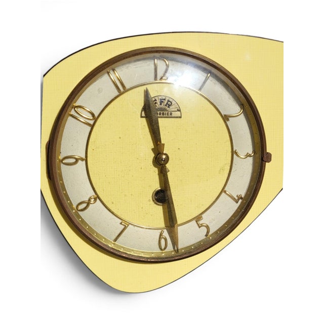 A 1950s-60s wall clock from the ffr factory in morbier (jura), typical of the "formica" clocks of the era. Its free-form,...