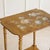 A two-tiered side table from the belle époque period, circa 1880–1900, with hand-painted floral decoration on a lacquered...