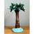 This candlestick takes the whimsical form of a full-scale palm tree, its slender trunk rising from a rounded island-blue...