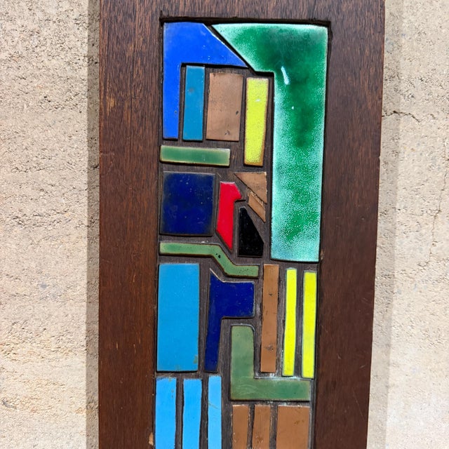 For your consideration, a vertical wooden wall art piece featuring a colorful geometric enamel on copper inlay. A dark...