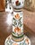 This colorful French faience candlestick is a classic example of Quimper pottery, celebrated for its hand-painted Breton...