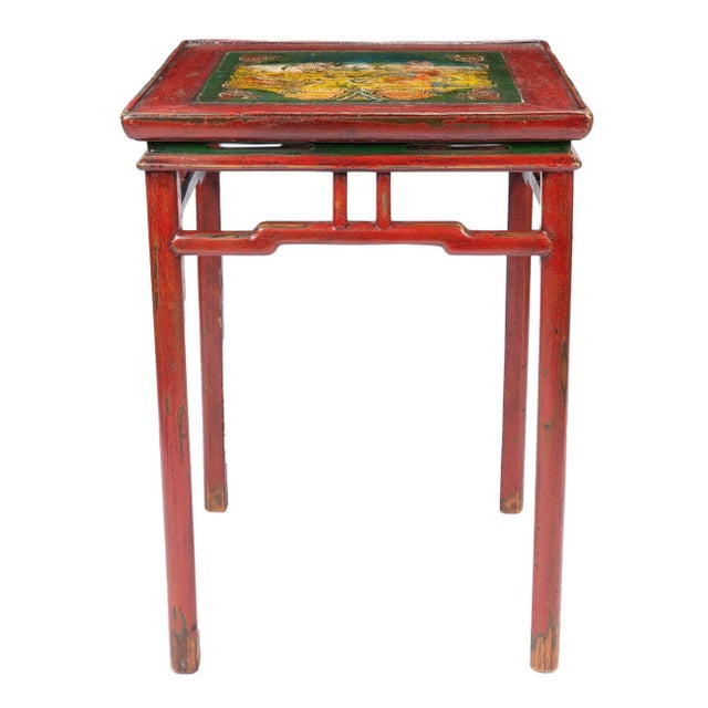 Tibetan red lacquered hard wood table with hump-back apron rails joining four turned legs. The painted table top features...