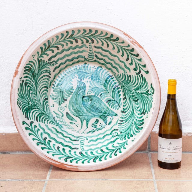 A Spanish Fajalauza lebrillo pottery bowl from Granada, hand-painted in green over a cream glaze, a large ceramic wall art...