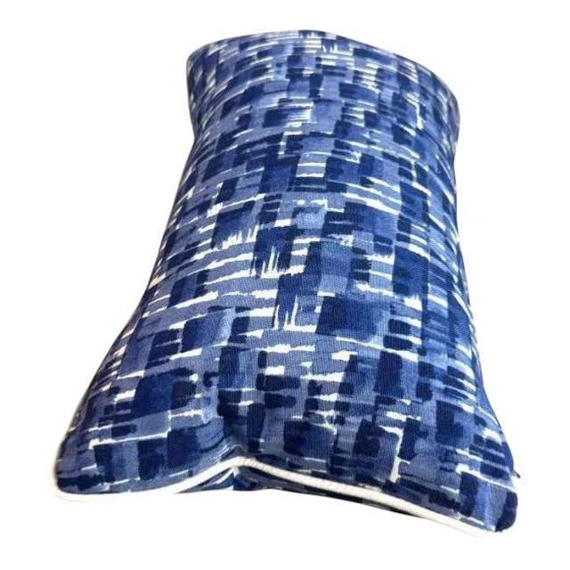 This dynamic pair of lumbar pillows showcases a bold brushstroke pattern in varying shades of blue with crisp white...