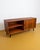 A compact 160 cm Danish teak sideboard from the 1960s with sliding doors and drawers. The diagonally tapered legs maintain...