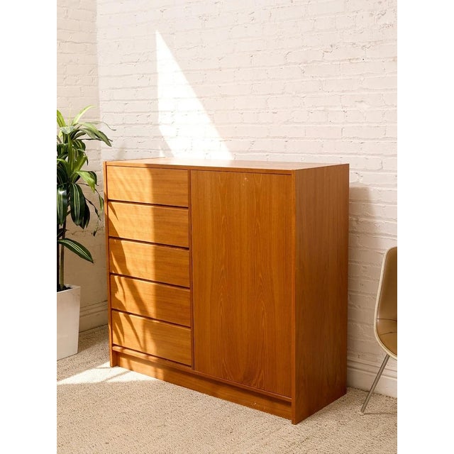 A handsome Danish modern cabinet dresser with a warm wood finish and a clean, architectural silhouette. The asymmetrical...
