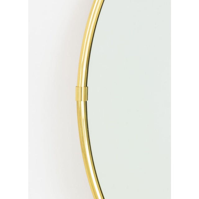 Modern Brass Framed Oval Mirror, the frame faceted. Mirror plate: 18" H x 30" W; frame: 20" H x 32" W x 1" D. Provenance:...