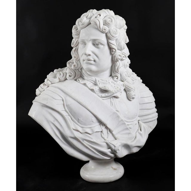 A beautifully sculpted antique Italian Carrara marble bust of a Nobleman in armour, mid-20th century in date. The subject...