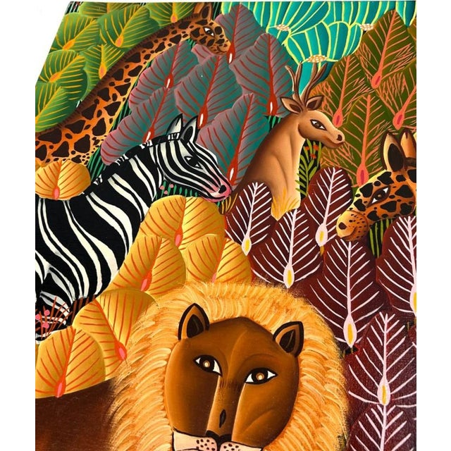 A delightfully rendered modernist folk art painting of a lively jungle scene complete with all manner of exotic animals....