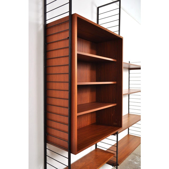 Wall unit modular wall system by combineurop from the 1960s. Beautiful black steel uprights with lovely legs, combined...