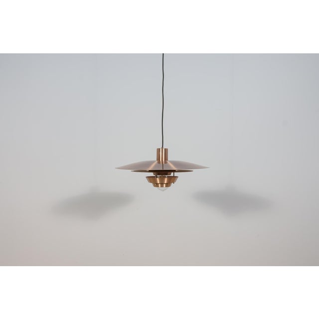 Penadant lamp manufactured in Denmark in the 1960s. It is made of copper, the inside is painted white. The lamp is in very...