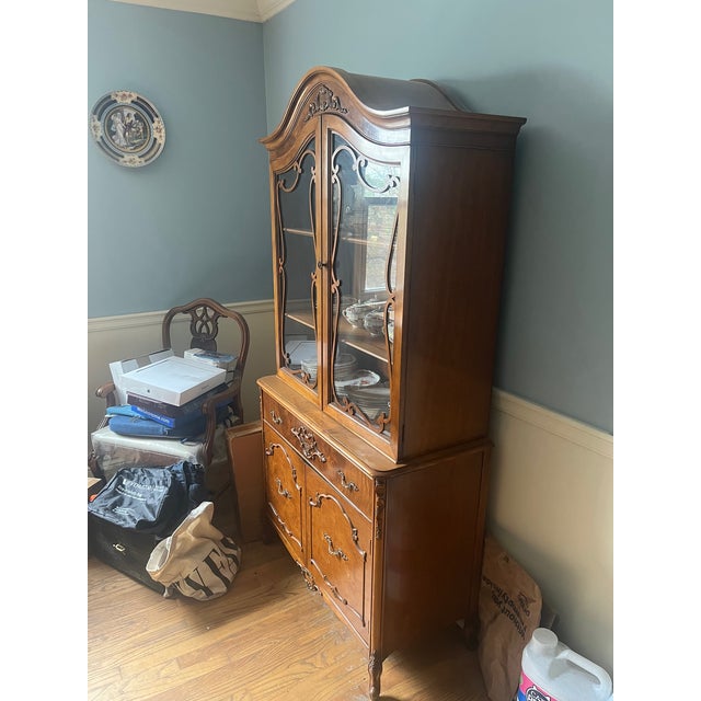 Magnificent Antique China cabinet that was purchased from a lovely estate. The wood has rich natural hues and patterns, it...