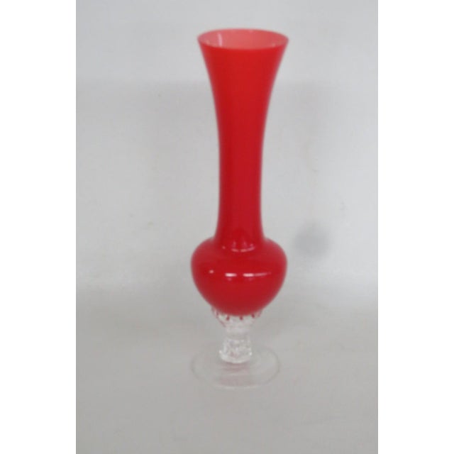 This lovely Slender Pedestal Vase is made of glass. This lovely vase has a beautiful ruby red color to the main glass and...