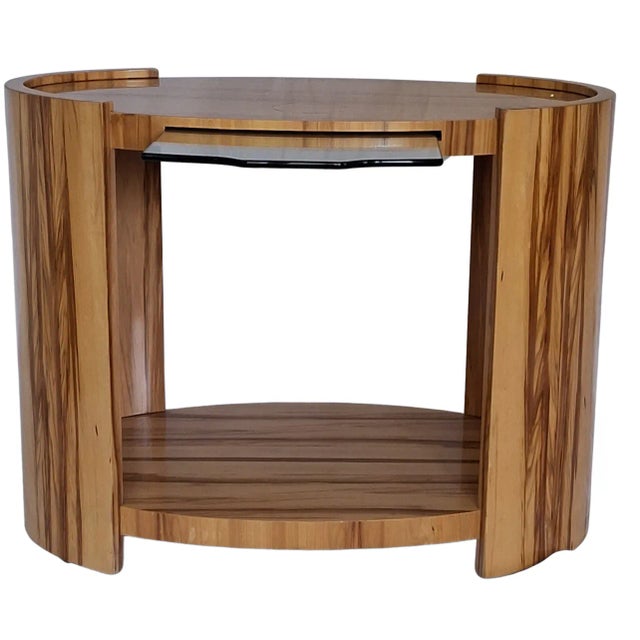 Presenting a one-of a kind hard maple side table in oval form with extendable glass shelf. It offers a stunning show of...
