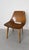 Pierre Guariche 1926-1995 Barrel-shaped chair, 1954. Molded plywood, wooden legs, and removable green seat cushion....
