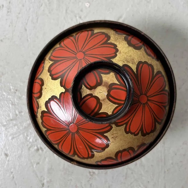Authentic rice bowl made of red and black lacquered wood (Urushi) with gold paint (Maki-e) and a floral decoration. The...
