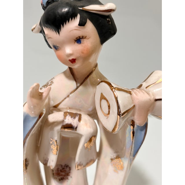 This vintage Japanese-style porcelain figurine features a graceful geisha or maiko figure in a flowing kimono with...
